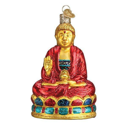 The Buddha 36257 Old World Christmas Ornament features a seated Buddha in gold glass with a red robe, jeweled base, and blessing gesture. Hand-painted and mouth-blown, it includes a metal loop for easy hanging on your tree.