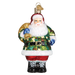 The Camo Santa 40299 Old World Christmas Ornament features hand-painted glass with Santa in a camouflage jacket, red pants, black boots, and carrying a gold sack over his shoulder.