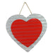 The 12 Corrugated Tin Double Heart Wall Hanging (HV910672) is a heart-shaped piece featuring vibrant red hearts in the center, elegantly suspended by a thin rope.