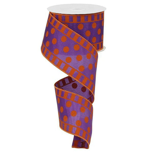 The 2.5 Satin Dots Stripes Purple Orange Ribbon (RG01460CY) is artistically coiled to showcase its bright orange polka dots and vibrant pattern, with the purple polyester wire edge providing structure on a white background.