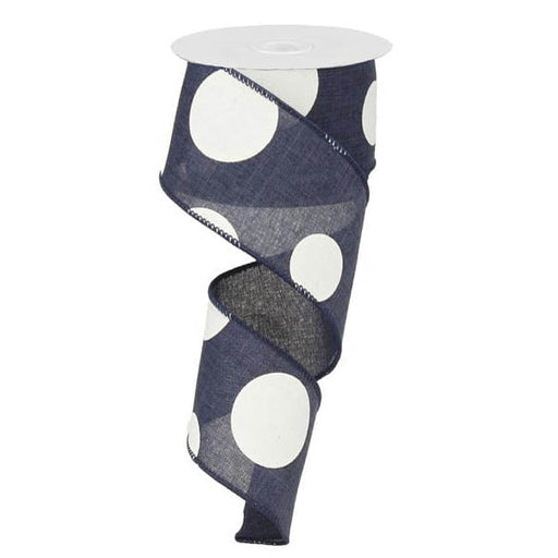 The 2.5 Large Multi Dot Navy Blue White Ribbon RX9143TR is a vertically coiled, partially unrolled ribbon with a sheer texture, large white polka dots, crafted from polyester and neatly wound around a white circular spool top.