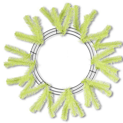 The Work Wreath 24 Lime Green from Holiday Creations features sparse artificial pine branches on a circular metal frame, creating a minimalist design that stands out against a pristine white background.