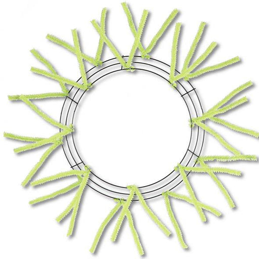 The 24 Lime Green Pencil Wreath XX750437 features a circular metal frame with lime green pipe cleaners extending outwards like sun rays, forming an open center against a plain white background.