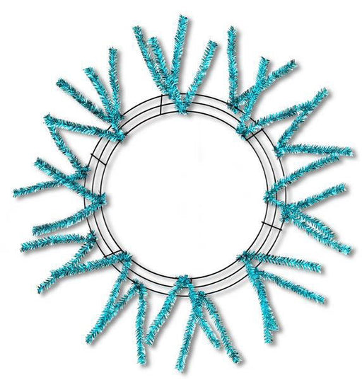 The 24 Turquoise Metallic Pencil Wreath XX751130 features a metallic turquoise frame with tinsel branches radiating outward. Its pencil work design forms concentric circles for elegant support, while the open center serves as a striking focal point.